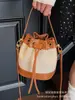 Bolsos de Diseño Nicho para Mujer 2025 Nuevo Verano Versátil Super Popular Bolso Cruzado Estilo Coreano Cordón Mini Bolso Cubo