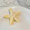 Blogger coreana estilo ins presilha de cabelo estrela-do-mar azul céu doce vento fresco férias na praia presilha de bico de pato geométrica presilha lateral presilha para franja