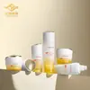 Frascos cosméticos com gradiente de branco para amarelo com tampas douradas, frascos de vidro para cuidados com a pele, essência, loção e creme conjunto completo de frascos, atacado do fabricante