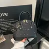 Bolsa de mão feminina de nicho estilo coreano, novo modelo primavera 2026, bolsa concha estilosa e simples, bolsa transversal elegante e moderna