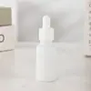 Botella gotero de porcelana blanca con puntos para aceite esencial de 10 ml, botella de vidrio a prueba de luz para productos de cuidado de la piel, botella vacía para muestra de esencia líquida original