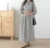 Vestido coreano Dongdaemun 2026 Otoño Temprano Nuevo de Manga Larga Rayas Estilo Fresco de Botón Único Holgado Cuello Redondo Hasta la Rodilla