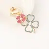 Llavero creativo de trébol de cuatro hojas incrustado de diamantes colgante de llavero de lujo ligero para bolso aleación cuatro flores