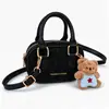Bolsa Infantil Ligera Mini Unisex Bolsa de Bolos para Niños Estilo Coreano Bloque de Color de Moda Accesorio con Colgante de Oso Lindo Bolsa