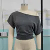 2026 Moda europea y americana para mujer Amazon nuevo top sexy corto de manga corta de color liso, cuello asimétrico, hombros descubiertos, manga ancha, entallado a la cintura