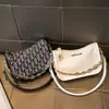 Pago de pedido Nueva Fuente Fábrica Bolso Mujer Moda Retro Lona Diseño de Nicho Cadena de Hombro Única Bolso de Mano para Debajo del Brazo