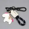 Llavero de Poni de Cuero Hecho a Mano Colgante con Cordón Anti-Pérdida, Llavero de Cuerda Tejida para Coche "Hazte Rico Pronto"