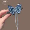 Pinza para el pelo de cristal azul con mariposa de nuevo estilo coreano y japonés, de lujo ligero, para mujer, pinza de resorte para flequillo lateral con borla, accesorio para el pelo versátil y elegante