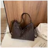 2026 nuevo bolso de hombro de lona de lunares de alta gama de nicho con lazo, bolso de mano de nicho, bolso de axila, bolso cruzado