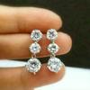 Aretes largos redondos de circonita Cao Shi Aretes de moda europea y americana para mujer Aretes súper brillantes que combinan con todo Venta al por mayor de fábrica