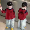 Camiseta de manga larga para niño, nueva 2026 primavera y otoño, camiseta básica de algodón puro, top casual coreano de cuello redondo para bebé niño