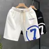 Verano 2023 nuevos shorts blancos estampados marca de moda para hombre pantalones deportivos holgados de cinco puntos pantalones de viaje para hombre Pantalones de playa