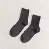 Meias novas femininas cor sólida algodão penteado japonês quatro estações meias cano alto preto e branco JK cor doce meias femininas simples atacado