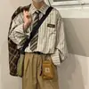 Nova camisa versátil e moderna de manga comprida, jovem e fashion, color-blocking, casual, padrão, artística, simples, primavera, estilo japonês para homens