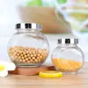 Venta al por mayor de fábrica Botella Transparente de Tambor Plano para el Hogar Sellada a Prueba de Humedad Tarro de Almacenamiento para Cereales y Frutas Secas Tarro de Almacenamiento de Vidrio Embotellado