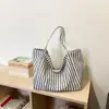Bolso de mano de rayas de alta gama transfronterizo 2026 nuevo bolso versátil para hombro o axila con un toque relajado y bolso tote de gran capacidad