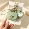 Nueva funda de espejo para auriculares de color sólido en forma de corazón, mini monedero simple, llavero portátil, accesorio de bolso de alta gama