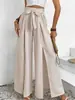 Pantalones de pierna ancha de cintura alta estilo europeo y americano 2026 con cintura de corbata, cintura elástica y una abertura frontal larga, creando un look fluido y elegante para mujer