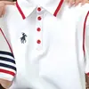 Camiseta Bordada de Manga Corta con Botones y Solapa Talla Grande para Mujer Primavera y Verano 2025 Nuevo Top de Moda Holgado que Adelgaza y Cubre la Piel para Mujer