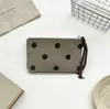 Nova porta-moedas de veludo cotelê com bolinhas, uma bolsa portátil para batom e maquiagem para mulheres, apresentando um design fofo e grande capacidade de armazenamento.