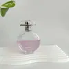 Botella de perfume redonda plana de vidrio de alta calidad, capacidad grande, bayoneta, botella con atomizador de presión, suministro en stock
