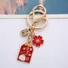 Nuevo Llavero de Bendición para Boda y Festividades Aleación Creativa Flor de Cerezo Lindo Colgante para Bolso Venta al por Mayor
