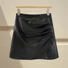 Falda irregular de piel sintética marrón para mujer, estilo otoño e invierno, combinada con botas, talla grande, estilo Miu, minifalda de línea A ajustada a la cadera