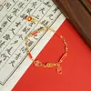 Nova Pulseira Dourada de Areia Estilo Chinês Antigo Pulseira Ruyi Vermelho com Gotejamento de Óleo Cartão de Bênção Palavras Auspiciosas Pulseira Joia Feminina Atacado