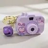 Cámara de simulación de proyección de dibujos animados llavero de moda colgante para bolso de niña pequeña juguete pequeño cuerda para la mano venta al por mayor
