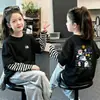 Camiseta de manga larga para niña, colección primavera/otoño 2026, elegante, algodón puro, look en capas, adecuada para niños mayores, diseño de dibujos animados, top de capa interior