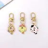 Colgante de gatito lindo de aleación estilo japonés Llavero de coche mini Colgante para AirPods Accesorio para bolso pequeño