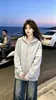Sudadera con capucha y cremallera de tres rayas en gris claro de estilo americano, moderna, fina y de corte holgado, adecuada para otoño e invierno