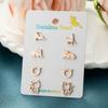 Pendientes de gatito lindos de versión mini de moda coreana, pendientes de traje combinado de acero inoxidable con borde cruzado, disponibles al por mayor