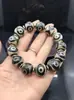 Venta al por mayor del fabricante Pulsera de cuentas Dzi de Xizang 16 mm Negra y Blanca Dzi Weathered B