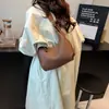 Nuevo bolso de moda para la axila de principios de otoño de 2026, bolso de mano estilo coreano, cuero suave, alto atractivo estético, bolso de albóndiga de nicho para mujer