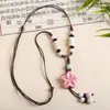 Collar con colgante de campana de mariposa de cerámica de estilo étnico retro para mujer, diseño nuevo y moderno, cadena larga para suéter, accesorios