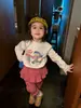Ropa Infantil Fruta Winnie 2026 Nuevas Llegadas de Otoño Ropa Infantil Estilo Coreano Ropa Infantil Niñas Estampado de Dibujos Animados Camiseta Blanca Estilo Versátil