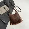 Bolso de hombro personalizado estilo coreano para mujer, nuevo modelo de verano 2026, bolso de mano y bolso de axila de gran capacidad con borlas, moderno y a la moda
