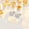 Nuevos aretes de amor huecos en forma de corazón con aguja de plata japonesa y coreana para mujer, simples y compactos, lujo ligero con un toque de alta gama, accesorios para orejas de mujer