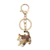 Llavero de gato esmaltado, colgantes surtidos multicolor, decoraciones para mochila de estudiante, accesorios de regalo para eventos festivos