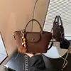 Bolsa de moda retrô de nicho transfronteiriça, bolsa de grande capacidade para mulheres, nova bolsa popular versátil de ombro e transversal para o outono de 2026