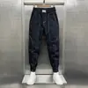 Pantalones holgados tipo harén con tobillo atado de estilo coreano para hombre, pantalones ajustados de línea brillante versátiles para jóvenes, pantalones casuales con tobillo atado de celebridad de Internet
