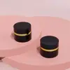 Material de Embalaje Personalizado de la Fábrica Mingfu Botella para Mascarilla Cilíndrica Borde Negro Dorado 5G/Abs Botella para Crema Botella para Crema Facial Botella para Crema de Ojos