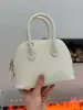 Bolsa de cuero genuino para mujer al por mayor en Guangzhou, mini bolso tipo concha de piel de vacuno TC de capa superior, bolso versátil para hombro y cruzado para el día a día