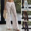 Nuevos pantalones casuales de comercio exterior transfronterizo europeo y americano con estampado de encaje, huecos, transparentes, cintura elástica, pantalones largos tipo falda de moda para vacaciones para mujer