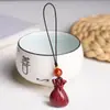 Colgante de bolso de cinabrio arena dorada púrpura cadena para teléfono móvil colgante para bolso de dinero de hombres y mujeres llavero colgante venta al por mayor generación sonido tembloroso