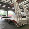 Venta de Precio de Descuento Buena Calidad 3 Ejes Transporte de Equipo Pesado Camión Plataforma 70 Toneladas 45 Pies Máquina de Gancho Placa Semirremolque