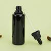 Suministro de fábrica botella de aceite negra botella de amatista negra europea botella de esencia de 100 ml botella con gotero botella de vidrio