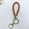Venta al por mayor del fabricante Llavero de Cuerda de Aleación Tejida y Cuero Accesorios Colgantes Material PU Bolsas Pequeñas de Regalo Accesorios para Llaveros
