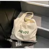 Bolso de Hombro Transfronterizo Nuevo Estilo 2026 Gran Capacidad con Estampado de Letras para Mujer, Bolso de Compras Fresco y Sencillo, Bolso de Tela Versátil para Mujer